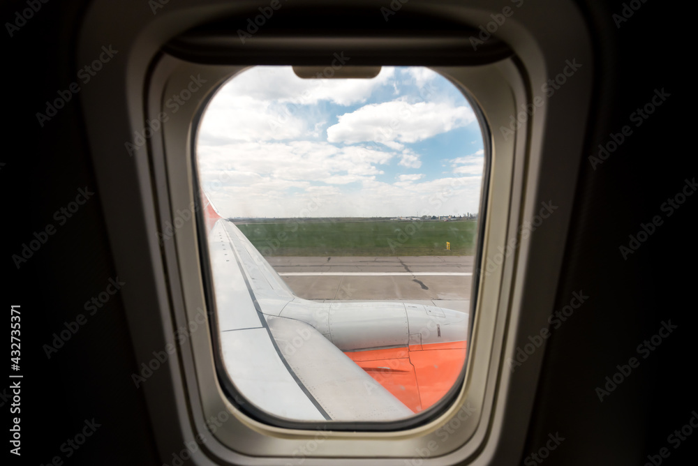 view from the airplane window of the airport during takeoff