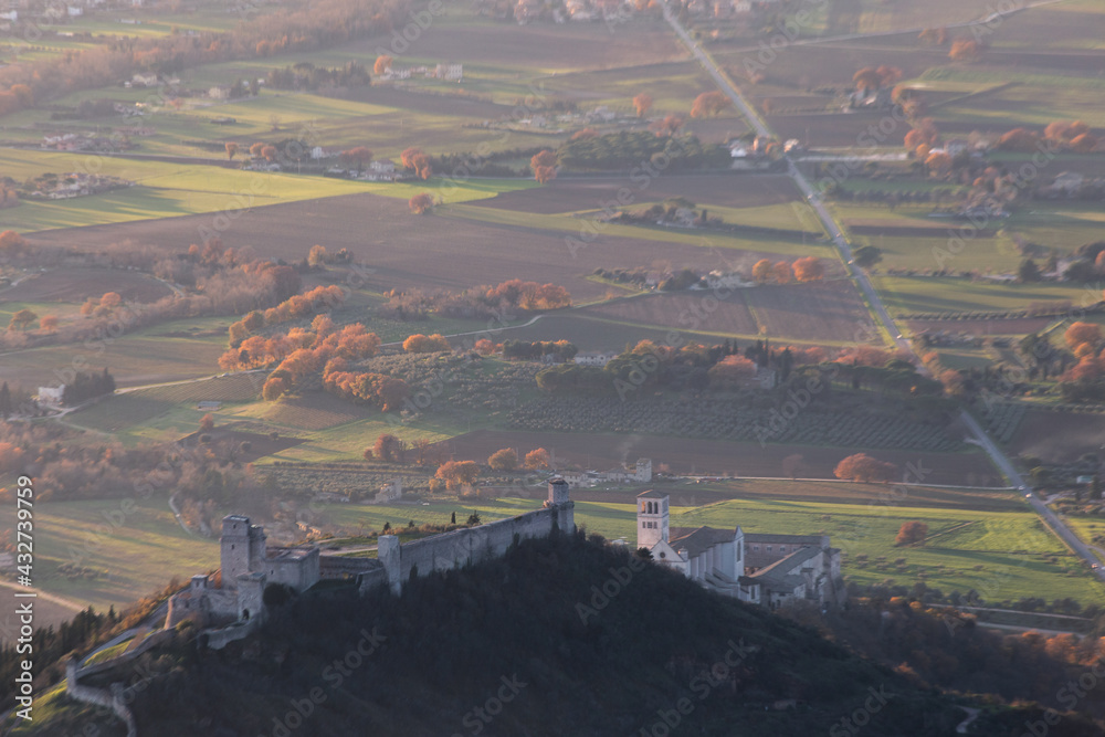 An aerial view of Assisi town, St.Francis church and Rocca Maggiore with country on the foreground