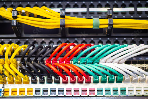 Multi-colored network wires. Colorful wires are connected to the internet switch. concept - rent of server equipment. Hosting equipment. Hosting server rent. Equipment for hosting provider