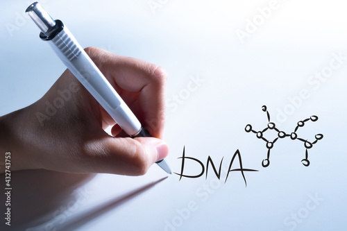 Hand with pen draws DNA log...