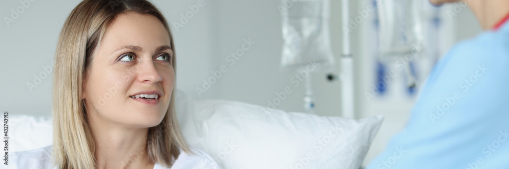 Doctor giving woman patient ballpoint pen in clinic Doctor giving woman patient ballpoint pen in clinic