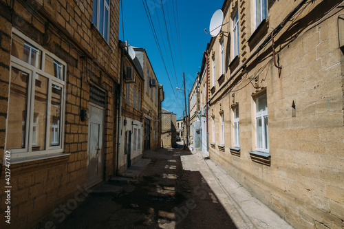 Old houses on low-rise narrow street in old part of Derbent city in Russia