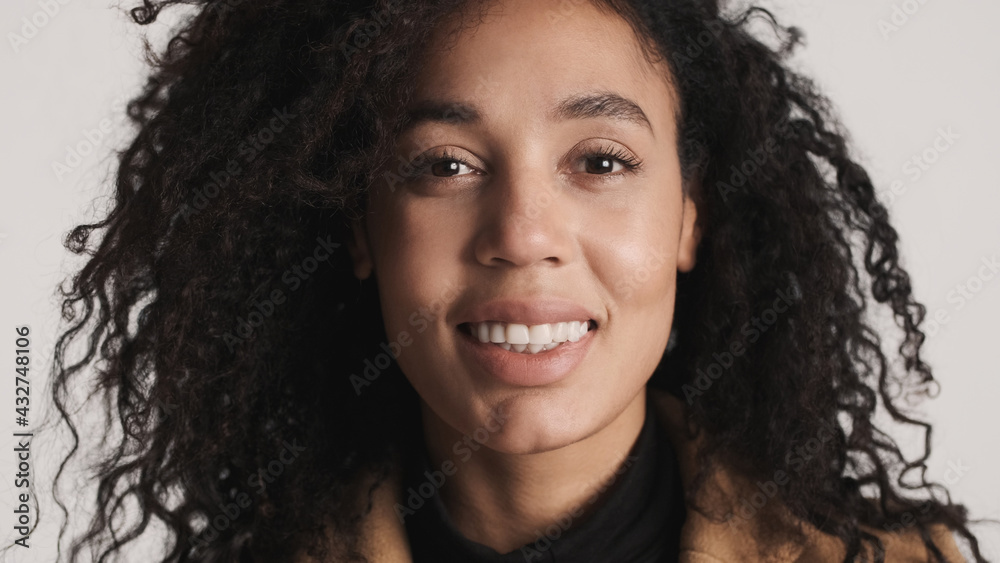 Close up beautiful African American woman with dark fluffy hair Close up beautiful African American woman with dark fluffy hair