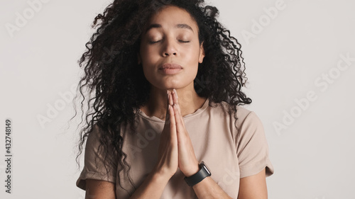 Beautiful dark fluffy haired African American woman showing plea