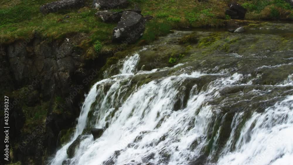 Waterfall stream on steep mountainside in Iceland, static zoom out view Waterfall stream on steep mountainside in Iceland, static zoom out view