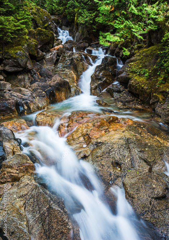Fototapeta premium Deception Creek tumbles over rocks in the Mt Baker Snoqualmie National Forest in the Cascade Mountains of Washington State 
