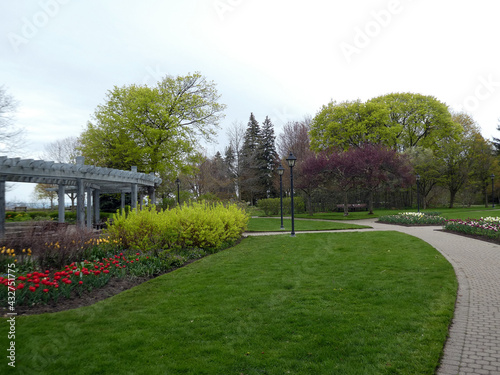 Park landscape with trees and flower bed © Lucy 