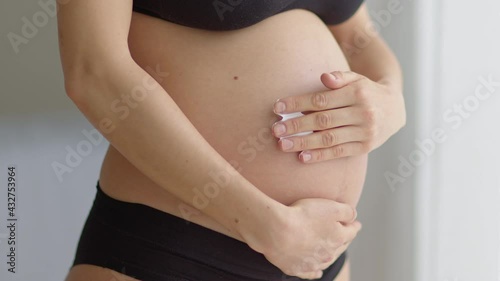 Wallpaper Mural Pregnant women putting anti stretch creme on her belly. Cosmetic for moisturizing or hydrating skin in pregnancy. Torontodigital.ca
