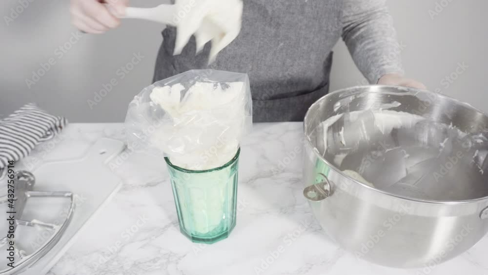 Step by step. Mixing ingredients in a standing kitchen mixer to prepare cream cheese frosting.