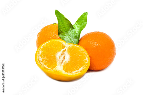 Group of whole and cut mandarines with green leafs on white background