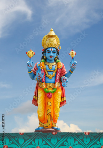 Hindu god Perumal statue on temple tower