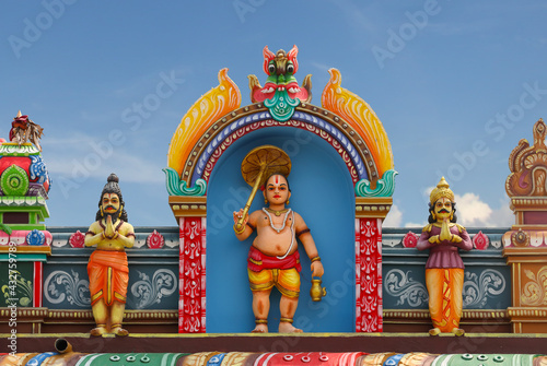Vamana avatar of Vishnu statue on temple tower	
 photo