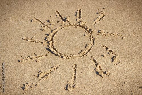 Shape of sun on sand at beach. Vacation time