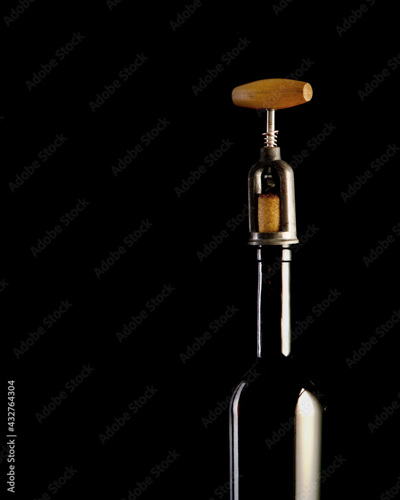 Red wine bottle with 2 glasses and bottle opener on black background. Red wine bottle with 2 glasses and bottle opener on black background.