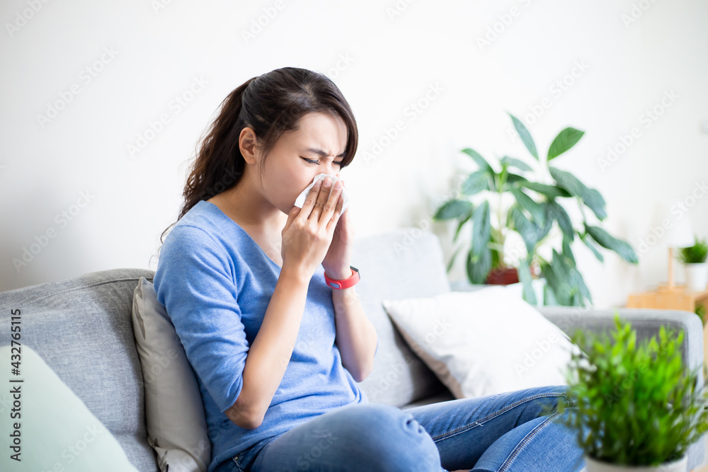 woman sneeze with tissue woman sneeze with tissue