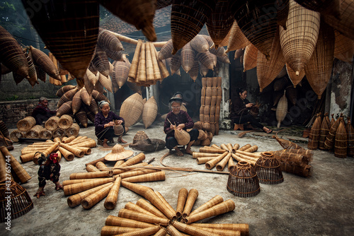Craftsman making bamboo fish trap at old village, Hung Yen, Vietnam