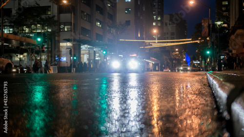 City Streets In The Rain At Night   Lights and Reflections Through Puddles On Street © Matt