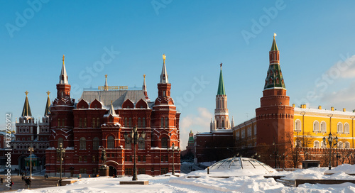 Scenic view of snow covered Manezhnaya Square overlooking building of State Historical Museum and corner Arsenal Tower of Moscow Kremlin, Russia..
