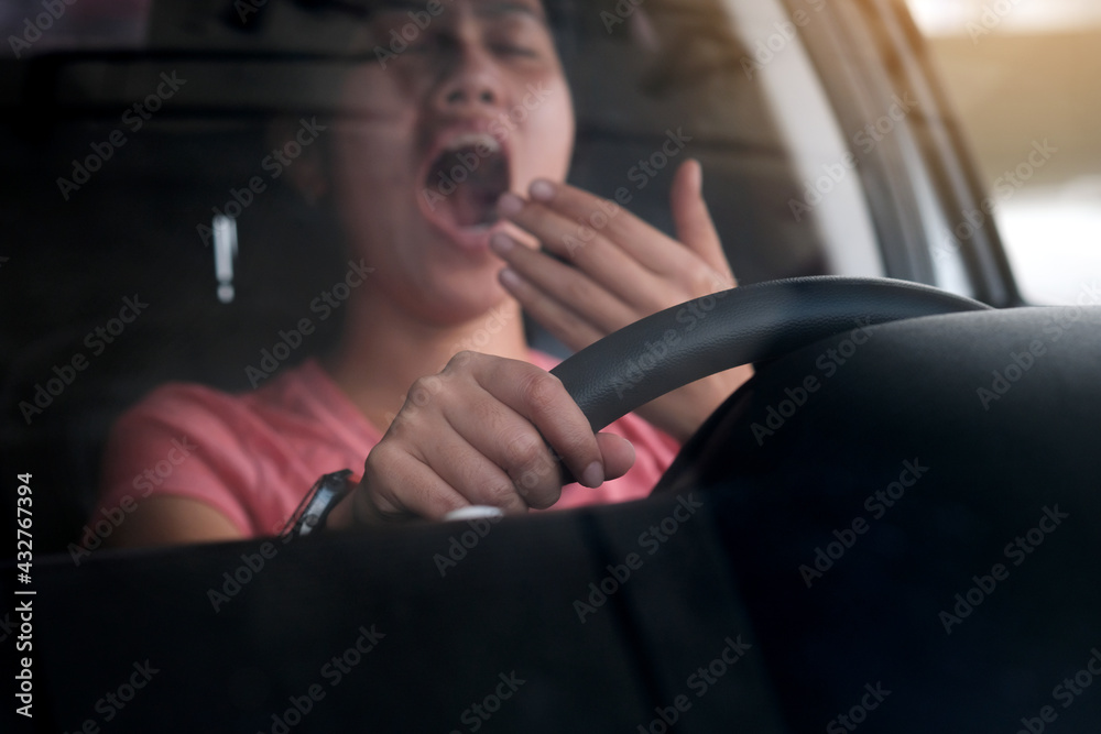 Sleepy woman While she was driving on the road. Concept of health and driving safety Sleepy woman While she was driving on the road. Concept of health and driving safety