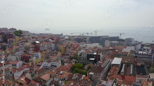 Aerial view overlooking the cityscape of Sao Bento, in cloudy Lisbon, Portugal - pan, drone shot photo