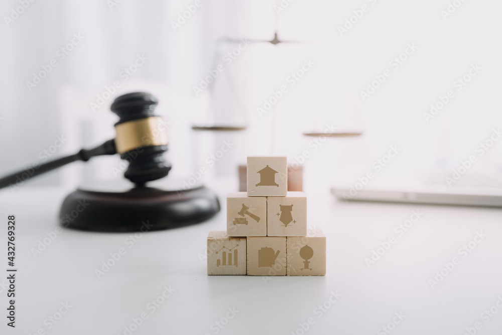Business and lawyers discussing contract papers with brass scale on desk in office. Law, legal services, advice, justice and law concept picture with film grain effect Business and lawyers discussing contract papers with brass scale on desk in office. Law, legal services, advice, justice and law concept picture with film grain effect