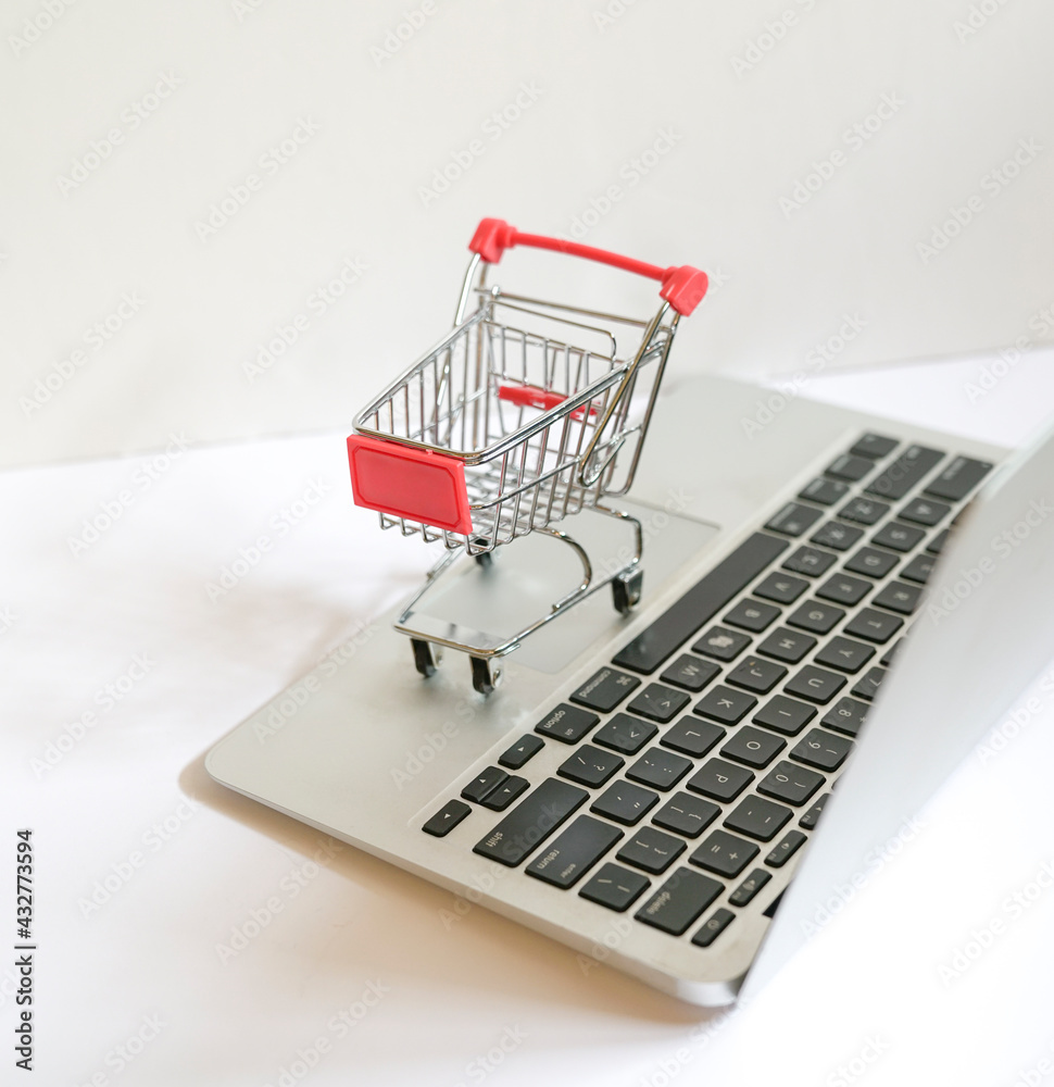 Online shopping concept : trolley cart on a laptop keyboard