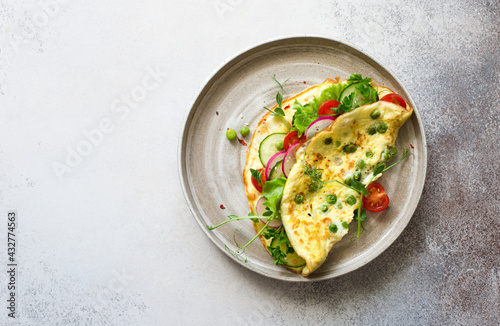 Omelette with raw vegetables- green peas, cucumber, tomatoes and greens