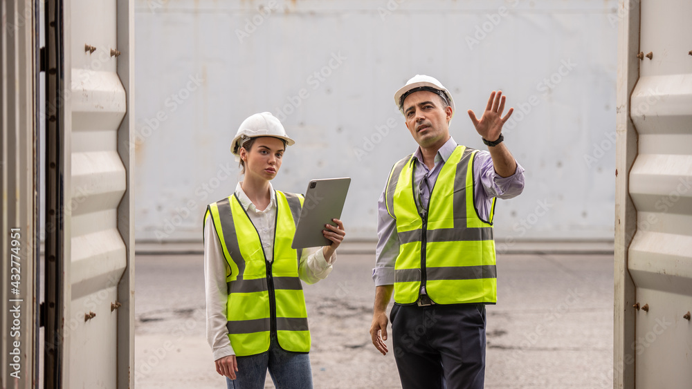 Boss and worker woman checking products results on the tablet at logistic and Explain for understanding about products. Boss and worker woman checking products results on the tablet at logistic and Explain for understanding about products.