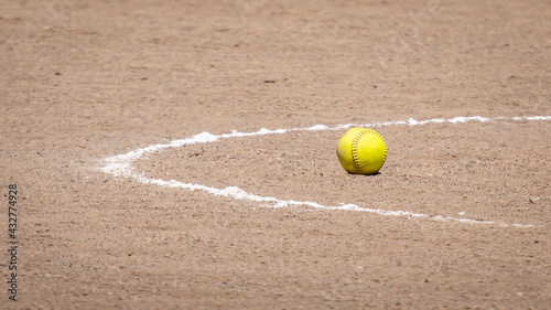 Yellow Softball in Pitching Circle on Dirt © MyPhotoBuddy