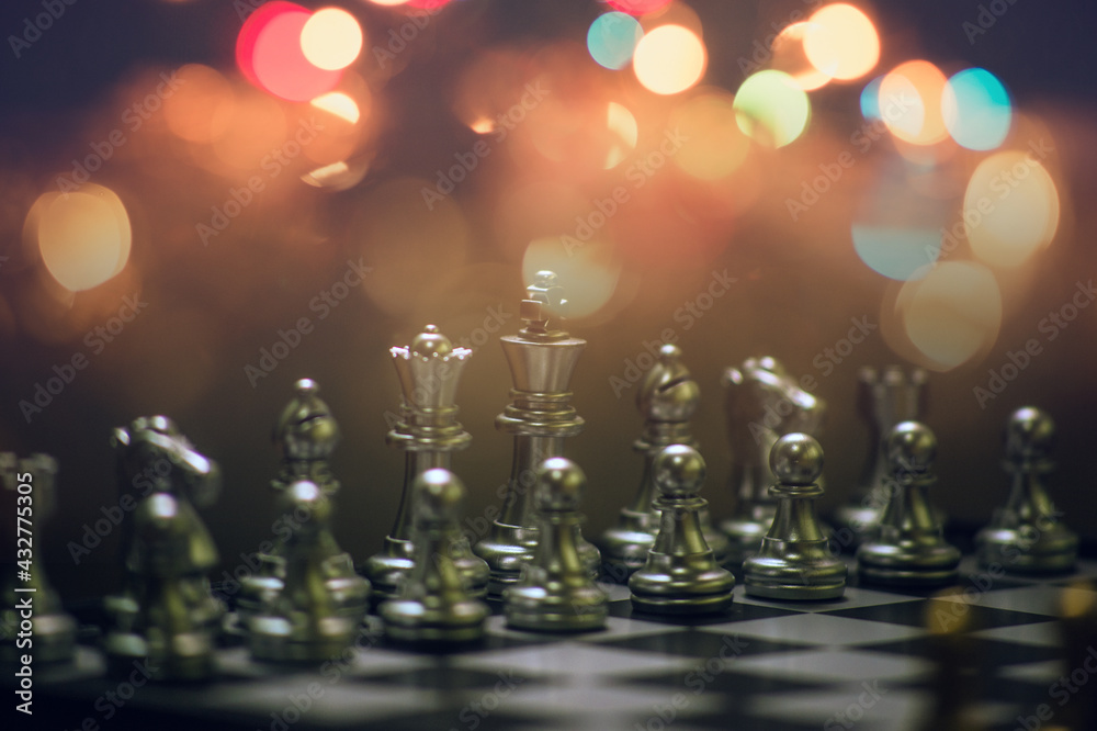Chess on the board, chess business strategy, stock market, blurred background, bokeh.