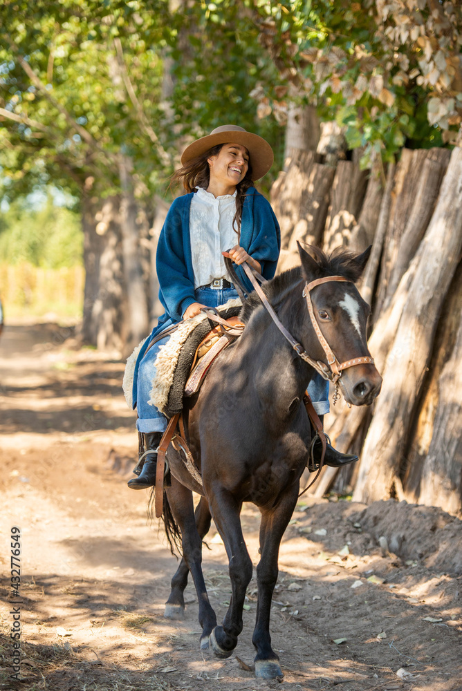 young latin woman riding a horse