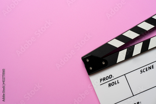 Картината върху платно movie clapper on table with pink background; film, cinema and video photography