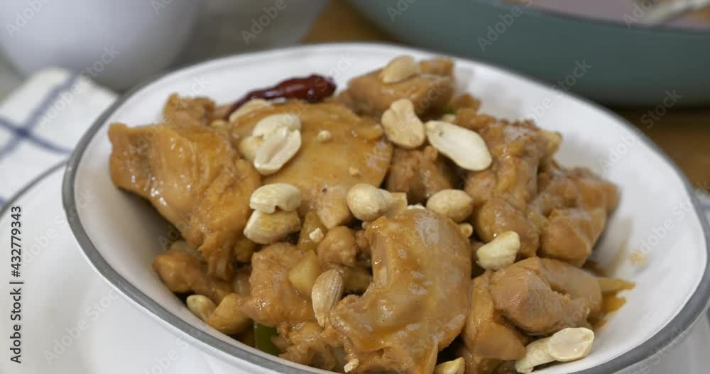 Peanuts falling onto a dish of Chicken Kung Pao
Peanuts falling onto a dish of Chicken Kung Pao