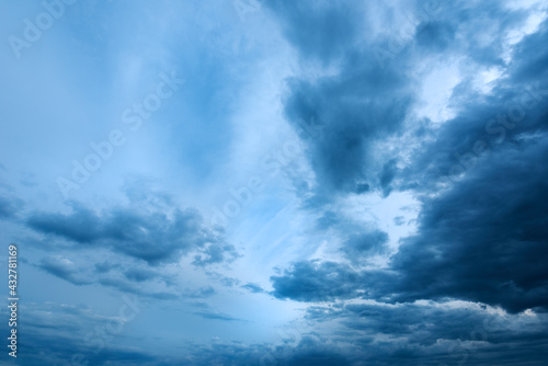 Dramatic stormy cumulus clouds at the sky in spring dusk