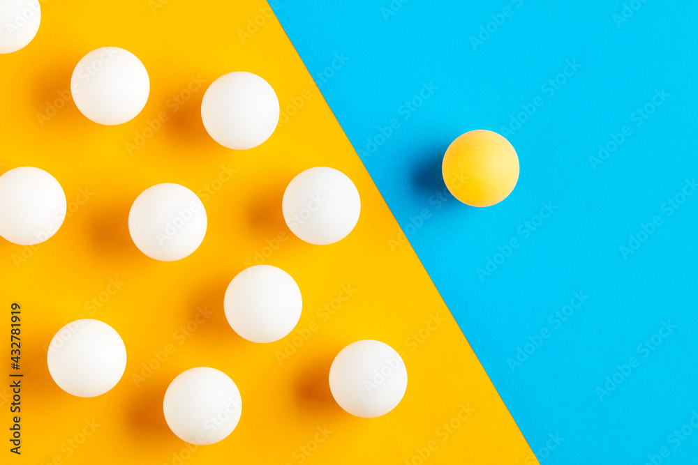 Table tennis balls in contrast. Diversity, difference, opposition, exclusion or confrontation Table tennis balls in contrast. Diversity, difference, opposition, exclusion or confrontation
