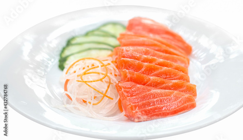 raw salmon red fish with vegetables on white plate