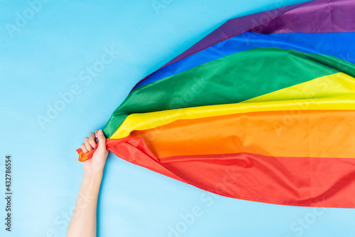 hand is holding the rainbow flag