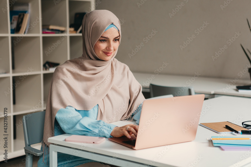 modern muslim woman in hijab in office room modern muslim woman in hijab in office room