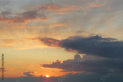 Beautiful black clouds in the sky at orange sunset, natural background