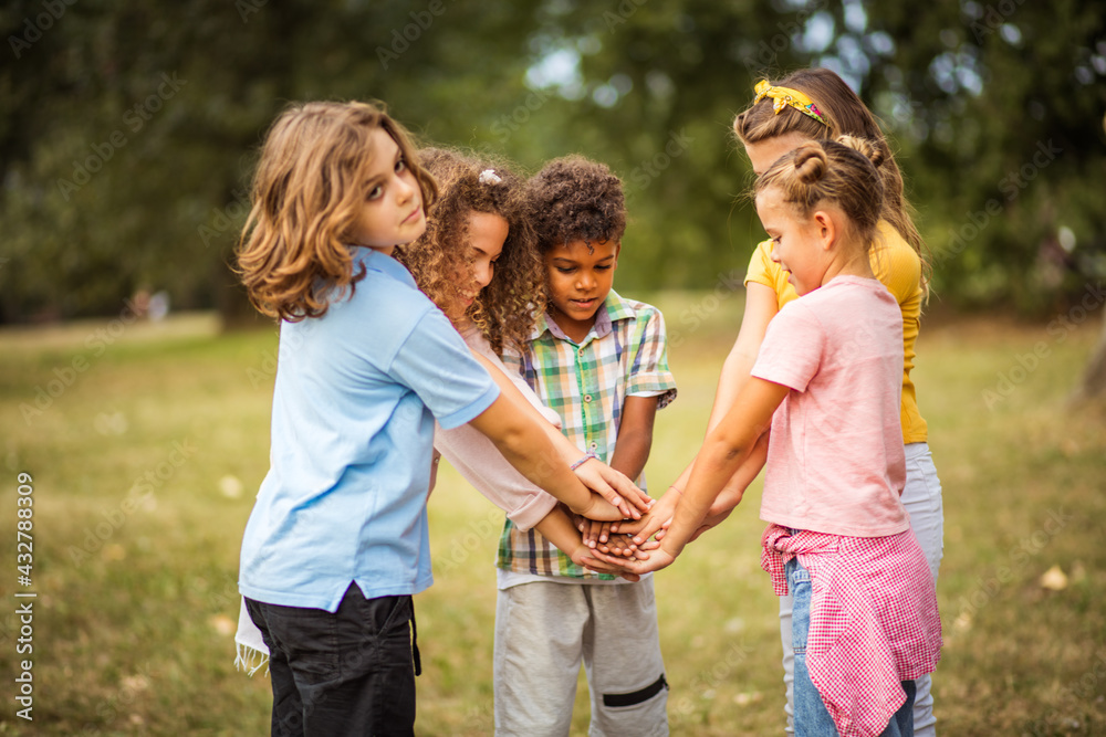 School friends will be together forever. Large group of school kids having fun in nature.