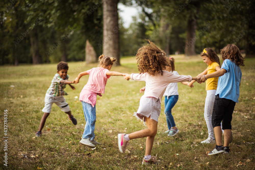 Large group of school kids having fun in nature. Happy kids dancing and holding hands. Large group of school kids having fun in nature. Happy kids dancing and holding hands.