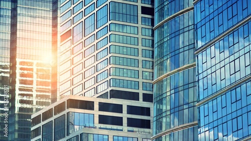 Modern building in the city with sunlight. Abstract texture and blue glass facade in modern office building., Retro stylized colorful tonal filter effect.