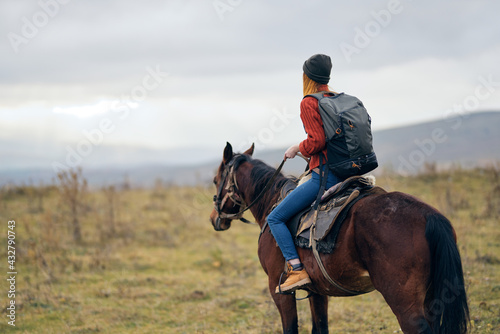 woman with backpack riding horse nature walk friendship