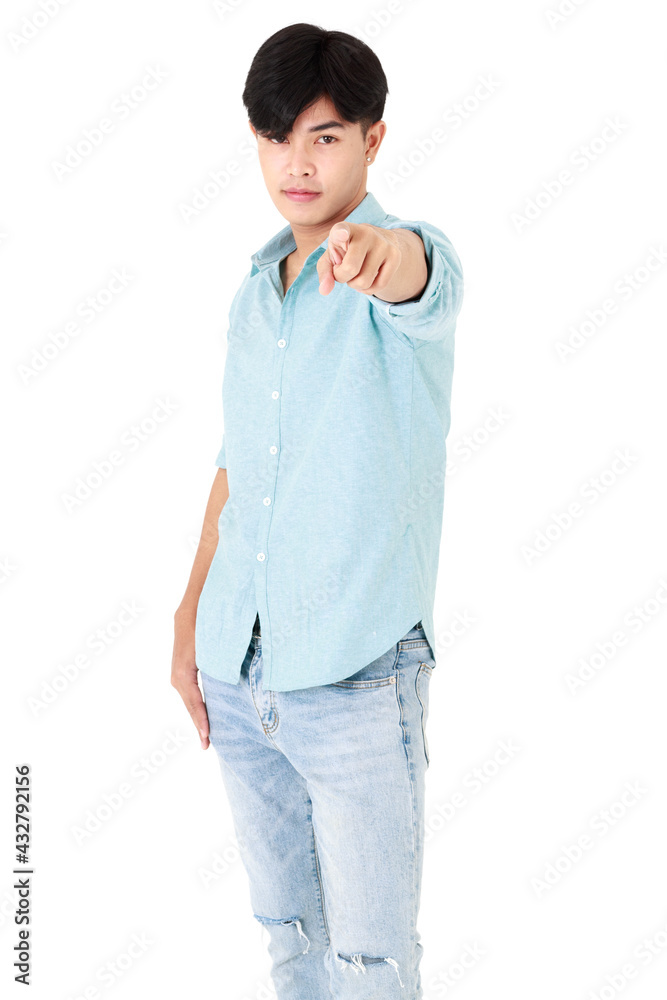 Fototapeta premium Asian handsome short black hair man wearing casual blue shirt and jeans, smart posing, pointing and looking at camera while standing on isolated white background cutout.