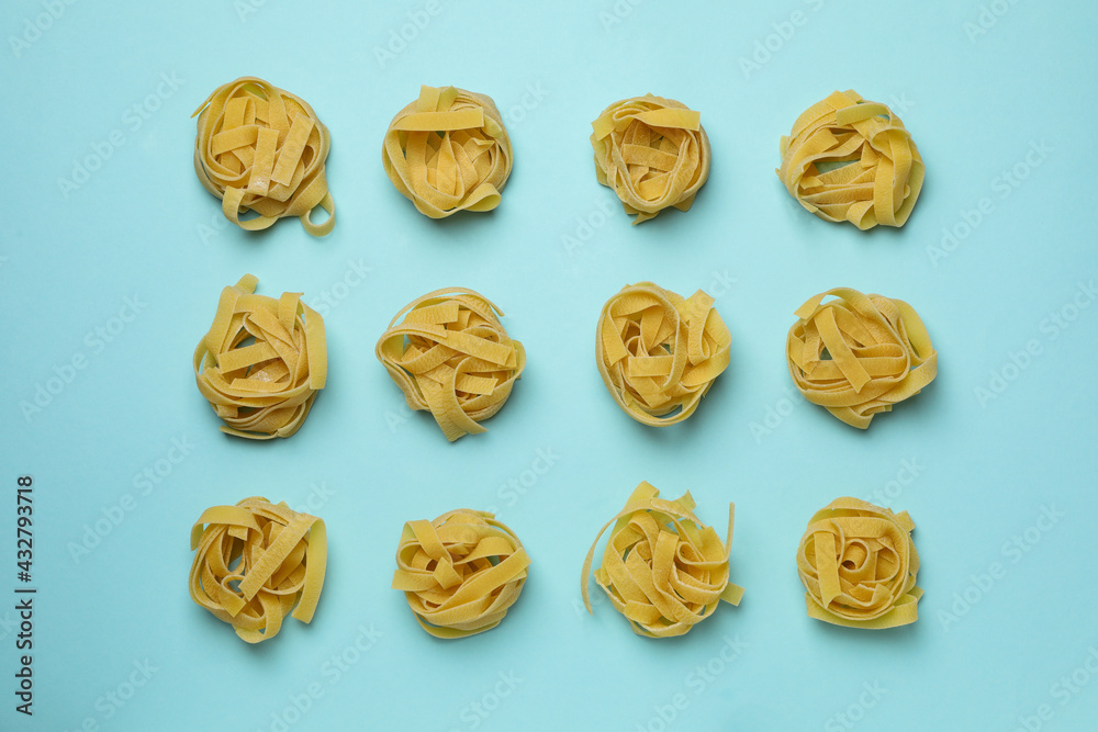 Flat lay with uncooked pasta on blue background Flat lay with uncooked pasta on blue background