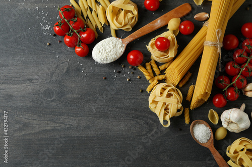Concept of cooking tasty pasta on dark wooden background