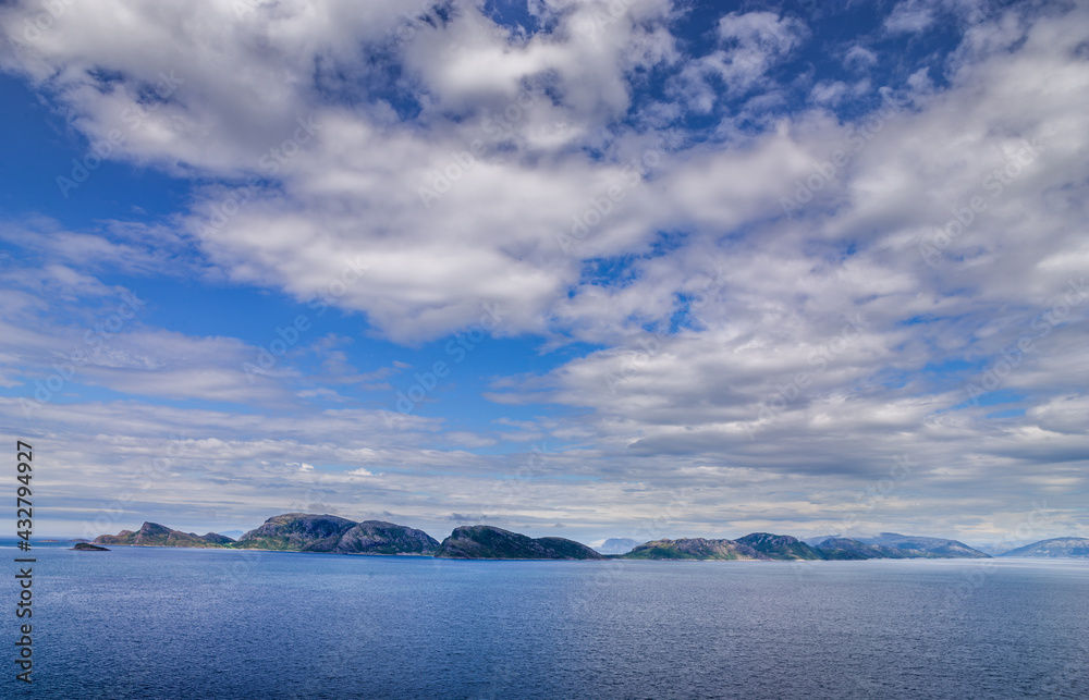 Landscape with small islands under overcast sky off the coast of Nordland, northern Norway
