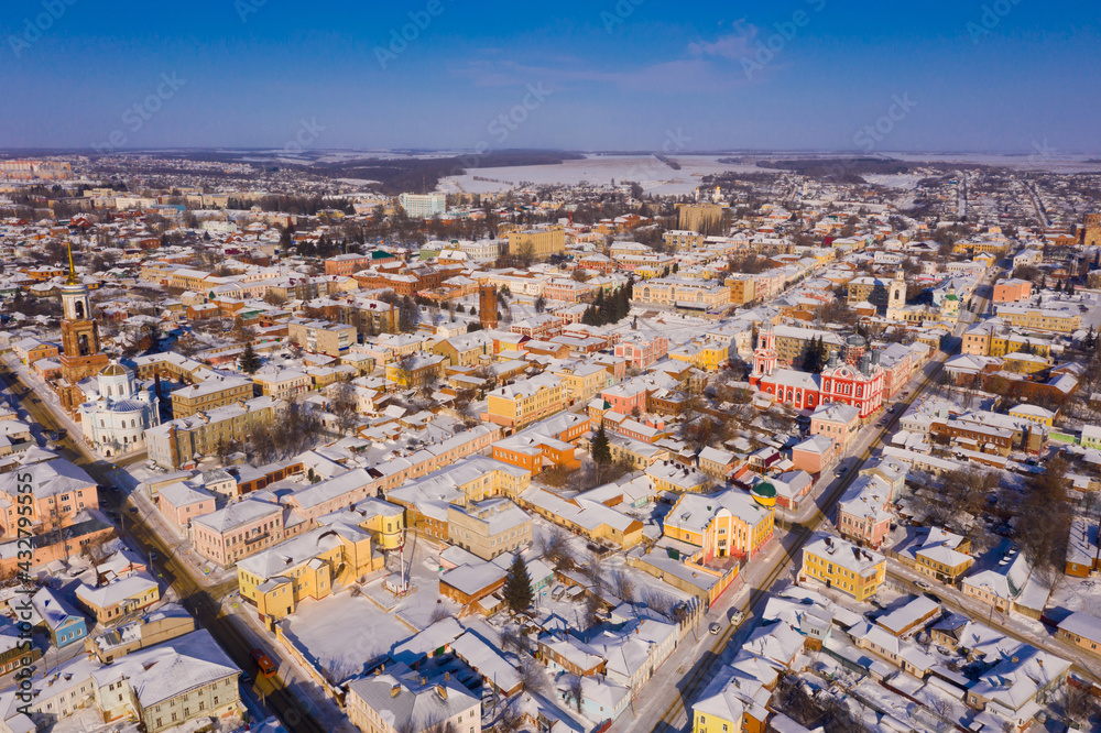 Scenic aerial view of covered with snow houses and churches in Russian city of Yelets on sunny winter day, Lipetsk Oblast