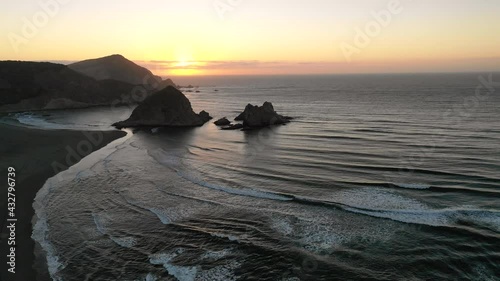 Amazing aerial view of a dreamlike beach in the central Chilean coast. Striking view of the waves coming from the sea and the wild coastline. A tranquil scenery in Topocalma beach during sunset time