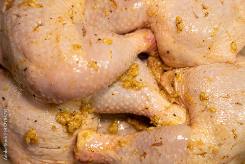 Marinated chicken legs are in a container